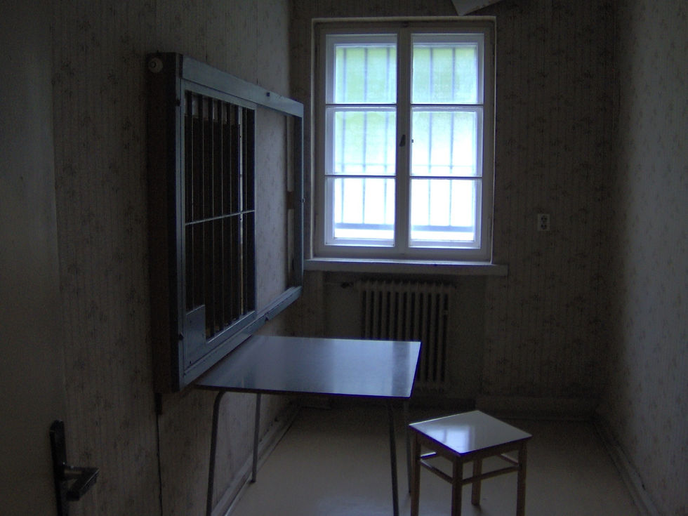 An interrogation room at Hohenschönhausen with a small table, a stool and a barred window