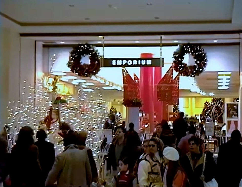 Emporium storefront decorated with wreaths and garland during the Christmas season.