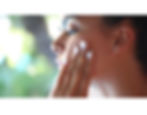 Woman applying Zeeta Body face scrub for acne