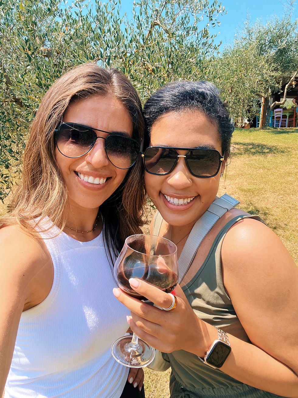 Solo female travelers drinking wine at a vineyard