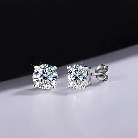 Moissanite geometric stud earrings on white surface against black background