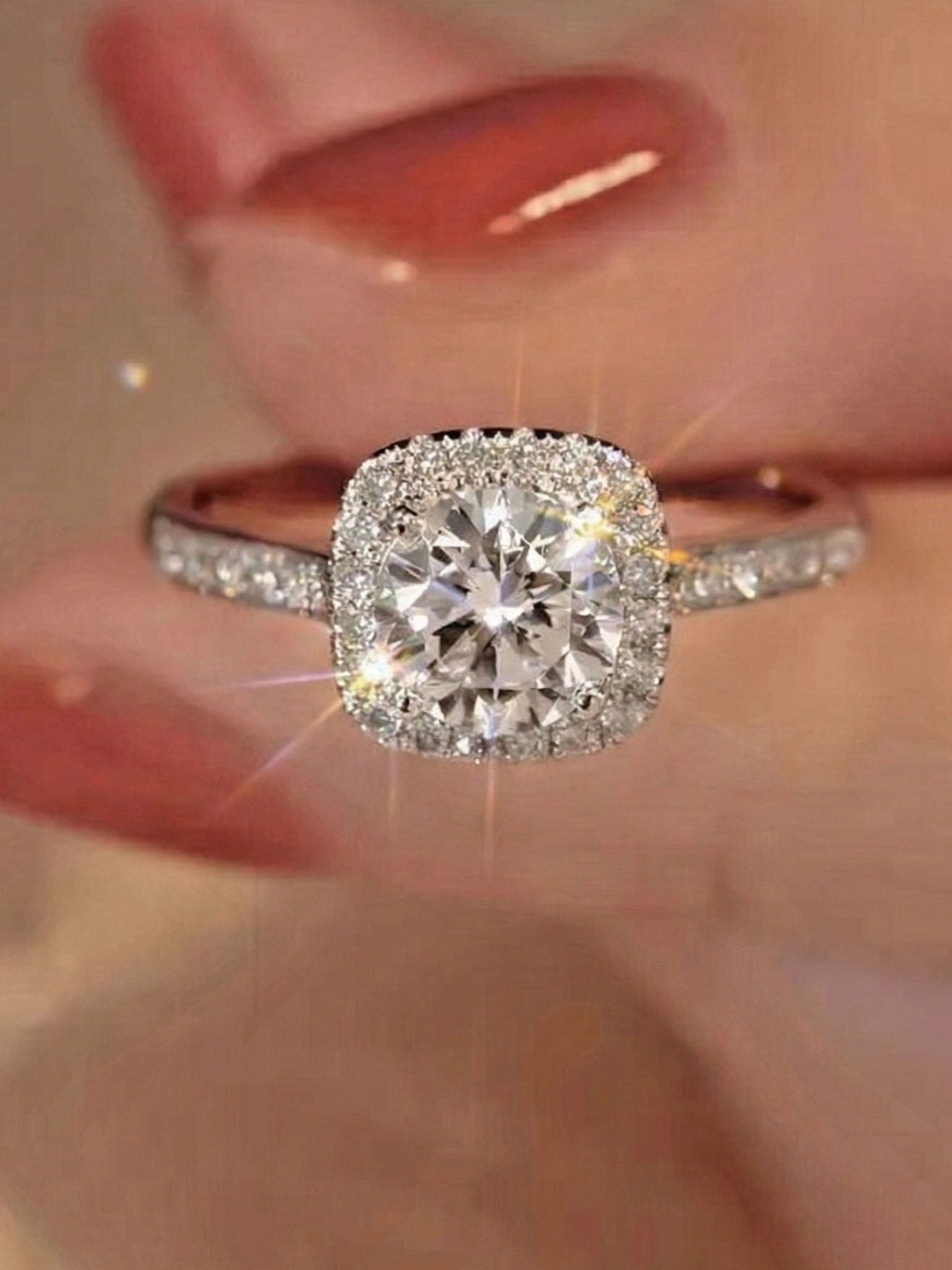 Moissanite ring held between fingers
