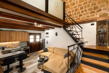 Open-plan living room and kitchen with mezzanine staircase — Casa Estiva, GK Luxury Suites, Rhodes Old Town
