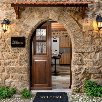 Casa Inverno entrance — arched medieval stone doorway, GK Luxury Suites, Lysippou 4, Rhodes Old Town