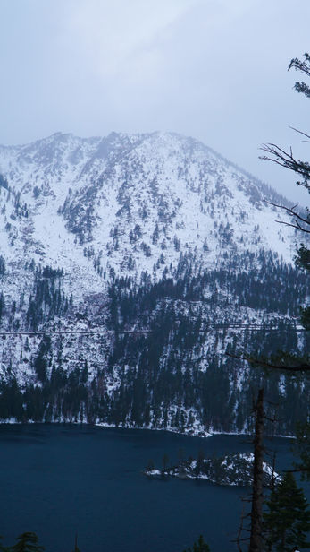 Snow-covered mountain over the lake, cloudy sky SOUTH LAKE TAHOE, beautiful landscape scene