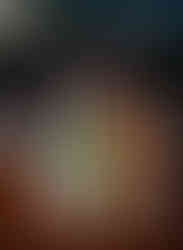 A colorful floral centerpiece with candles at a wedding reception in Austin, TX.