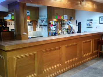 Wooden bar counter area inside Wembley Social Club