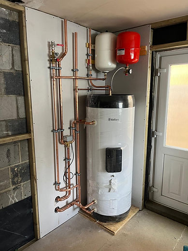 Woman using a digital tablet next to a modern wall-mounted boiler
