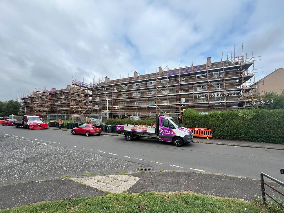 Construction scaffolding frameworks covering the exterior facade of a large brick building in Glasgow