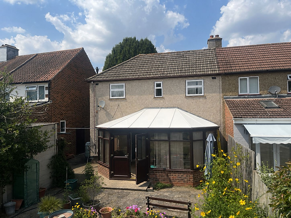 Conservatory with white tiled roof installed on a terraced home