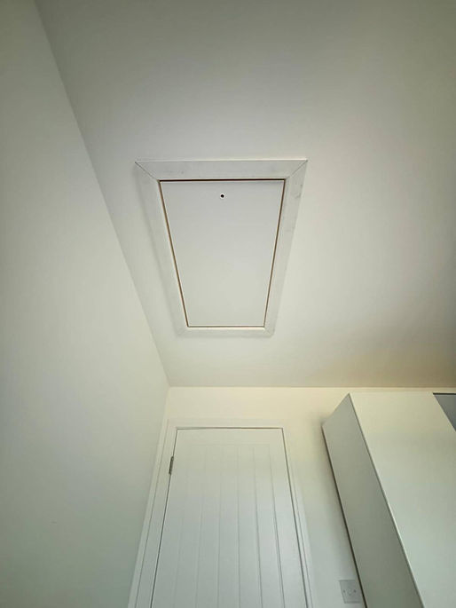 Closed square white plastic loft hatch installed cleanly into a ceiling