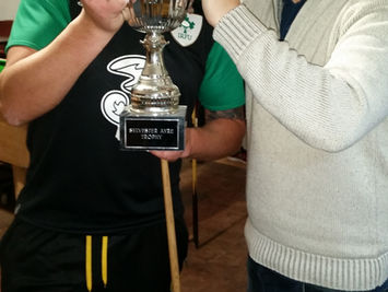 Club member holding trophy cup during presentation