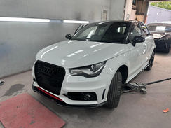 Professional car body repair workshop restoring damaged vehicle panels