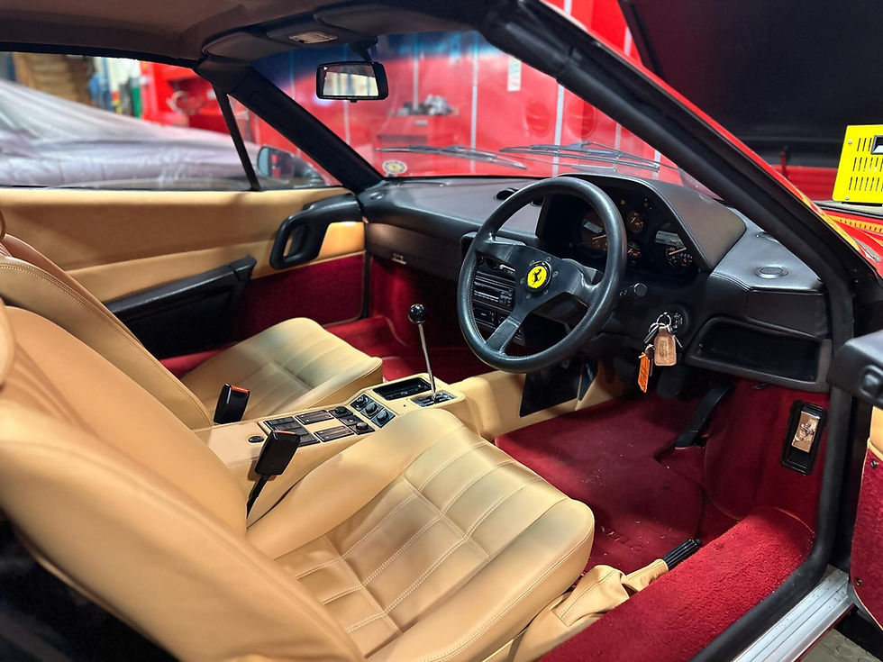 Inside a classic car with cream seats and red carpets