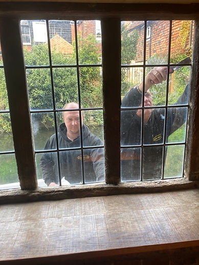 Handyman repairs plastic window with a hexagon