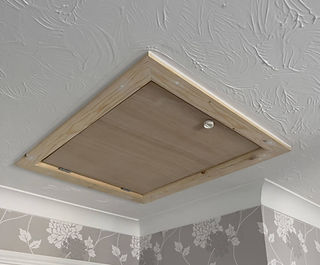 Closed rectangular white wooden hatch cleanly framed on a white ceiling