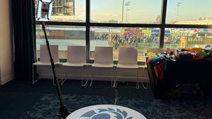 Guests striking fun poses on a 360 photo booth platform while the camera rotates around them.