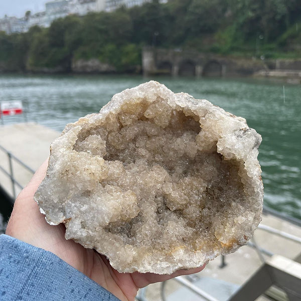 holding a beautiful big crystal with healing properties