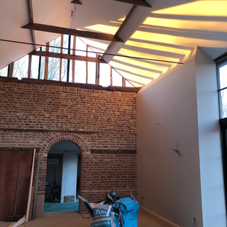 Stainless steel flue pipe passing through an exposed brick wall