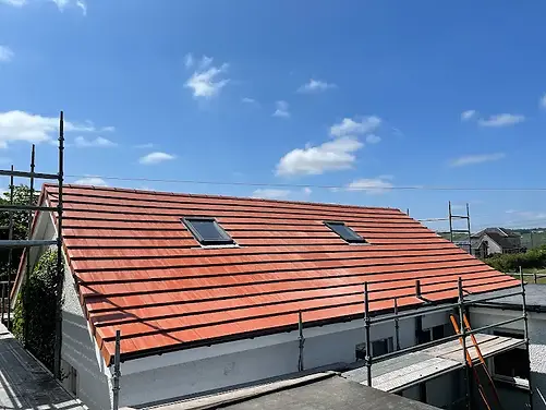 Red roof tiles on a detached house