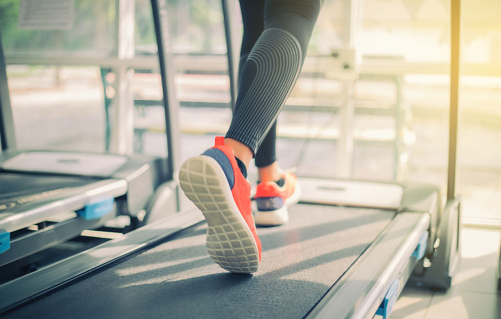 Running sport shoes at the gym while a young caucasian woman is jogging 