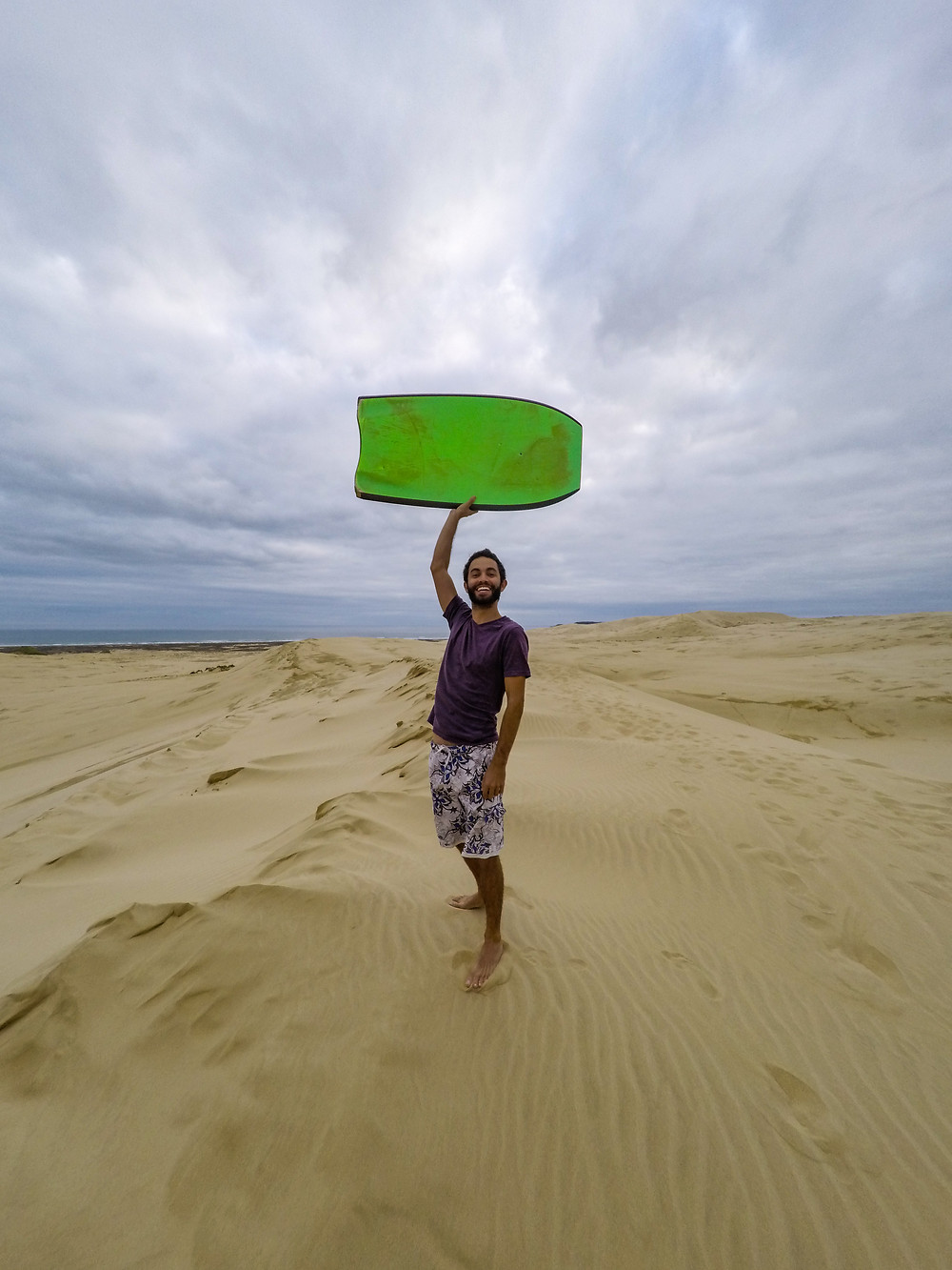 Sandboarding on te paki dunes new zealand