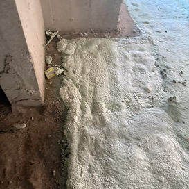 Textured foam insulation covers a floor,