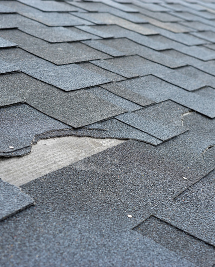 Wind damage to roof shingles
