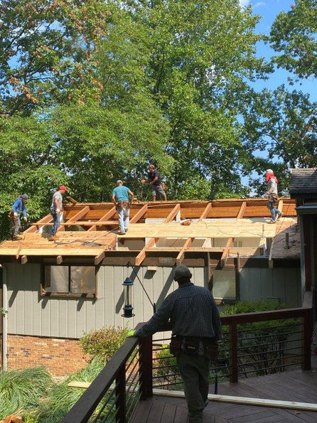 Roof shingles in process of being installed