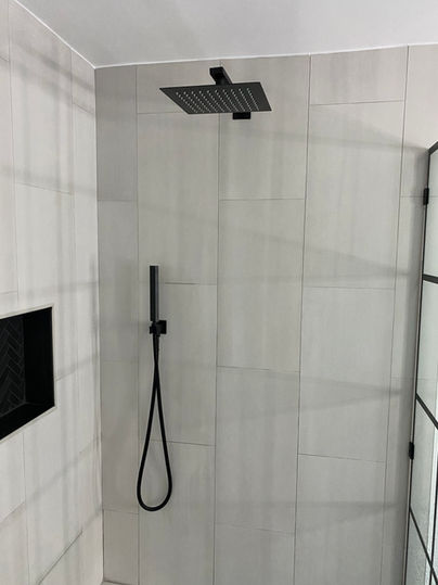 Large slab tile with black accents and niche