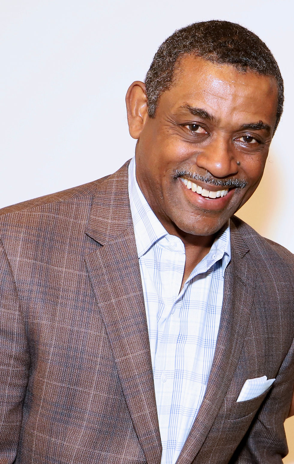 Portrait photo of T. Victor Edwards in a brown blazer