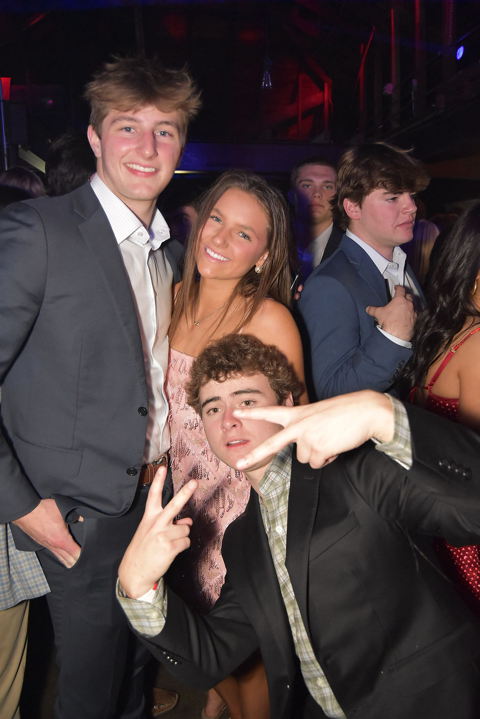 Friends posing in a photo booth event.