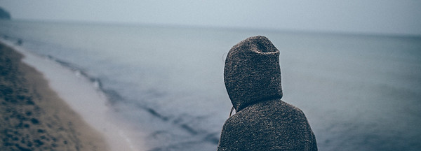 Man in sweatshirt on beach