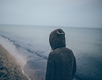 Man in sweatshirt on beach