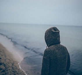 Man in sweatshirt on beach