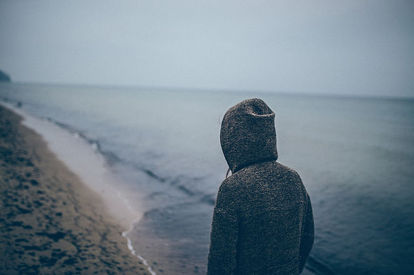 Man in sweatshirt on beach