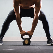 Muscular Man Lifting Kettle Ball