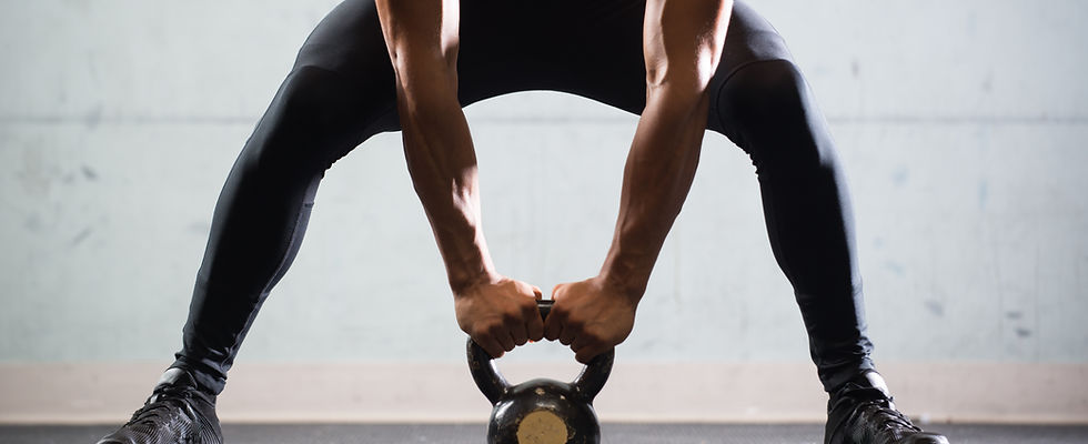 Muscular Man Lifting Kettle Ball