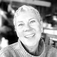 lady with short grey hair smiling