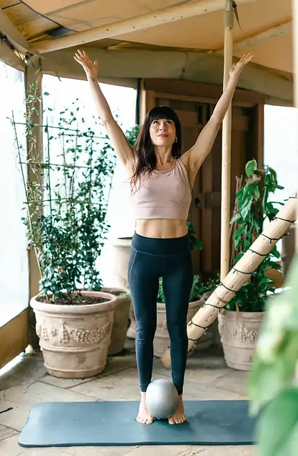 lady doing pilates arms stretched above head