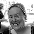 lady with hair tied back, smiling