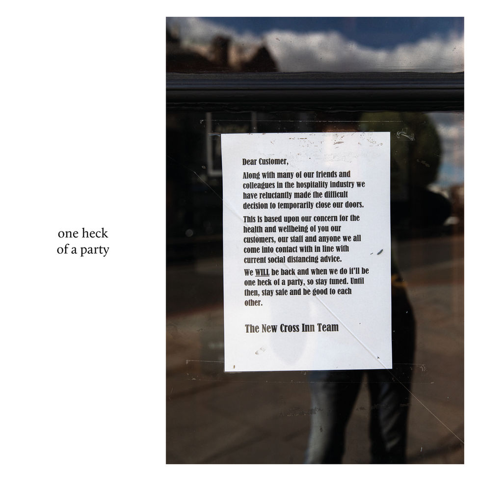 New Cross Inn closure notice in window, citing social distancing and future celebration.