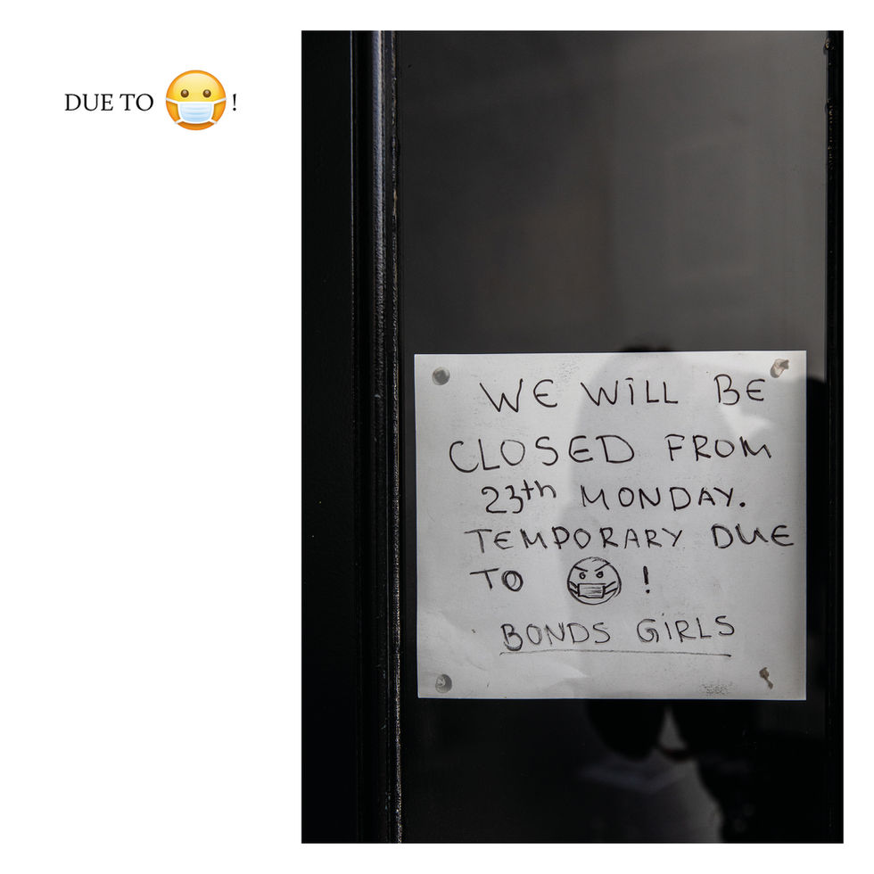Handwritten COVID-19 closure sign on a London shop door reading closed from the 23rd.