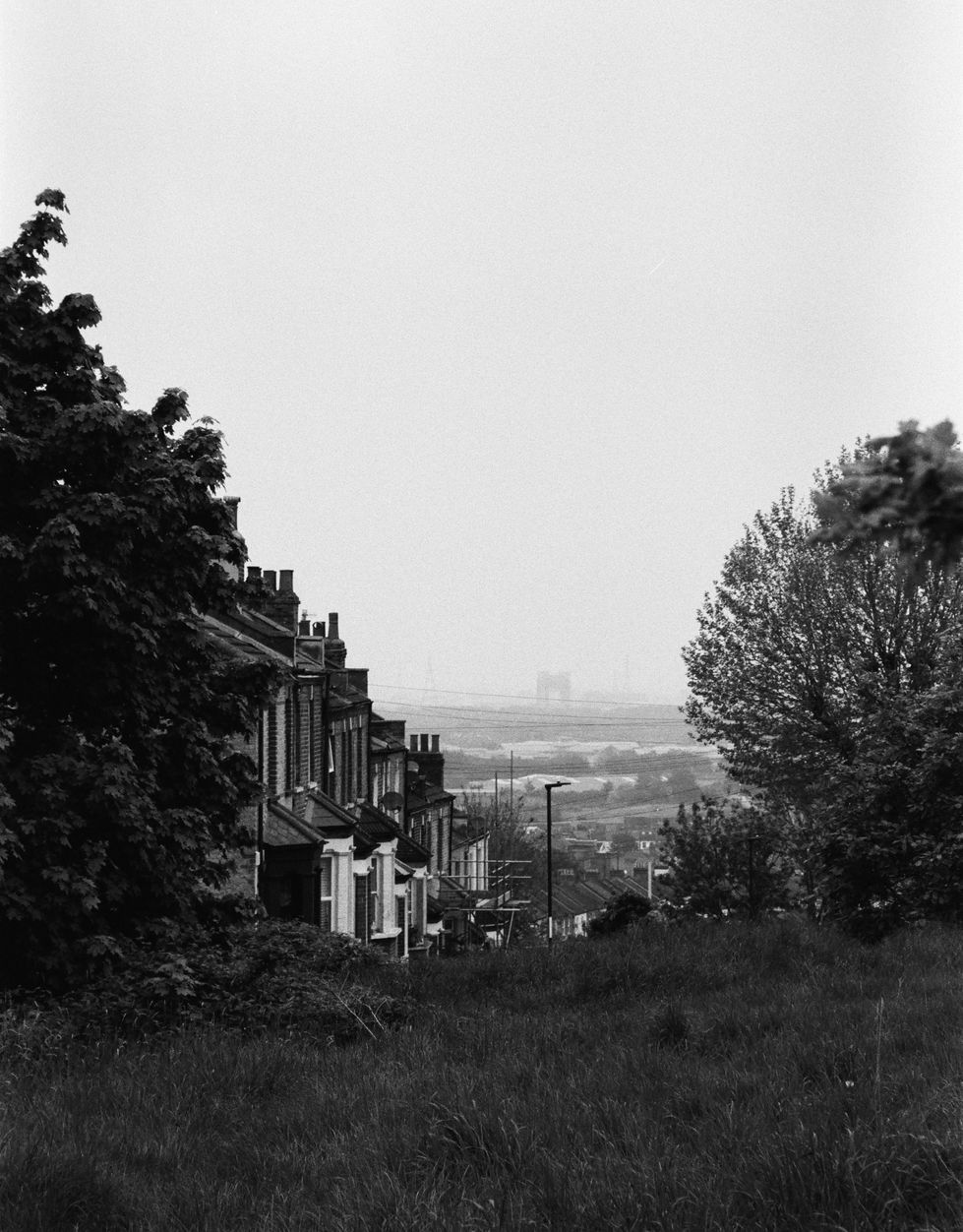 a black and white photo of a row of houses