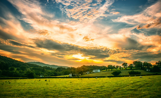 Sunrise over green fields representing God’s promise of abundant life