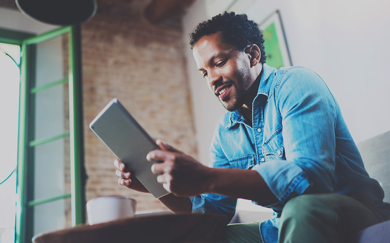 A Man Looking at his Tablet Device