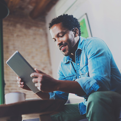 A Man Looking at his Tablet Device
