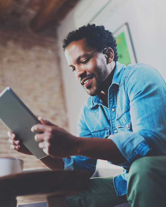 A Man Looking at his Tablet Device