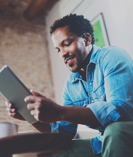 A Man Looking at his Tablet Device