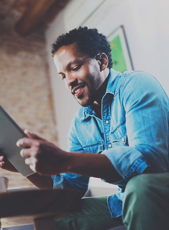 A Man Looking at his Tablet Device